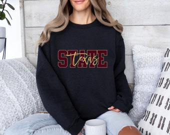 May include: A black sweatshirt with the text "Texas State" in maroon and gold lettering.