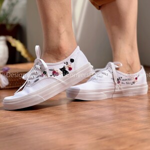 May include: White canvas shoes with black cat and floral embroidery. The left shoe has the text "My Beloved" embroidered on it.