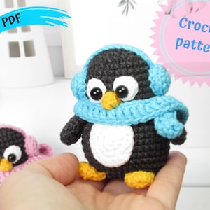 May include: Crochet pattern for a penguin amigurumi toy. The penguin is wearing a blue scarf and earmuffs. The pattern is available as a PDF download.