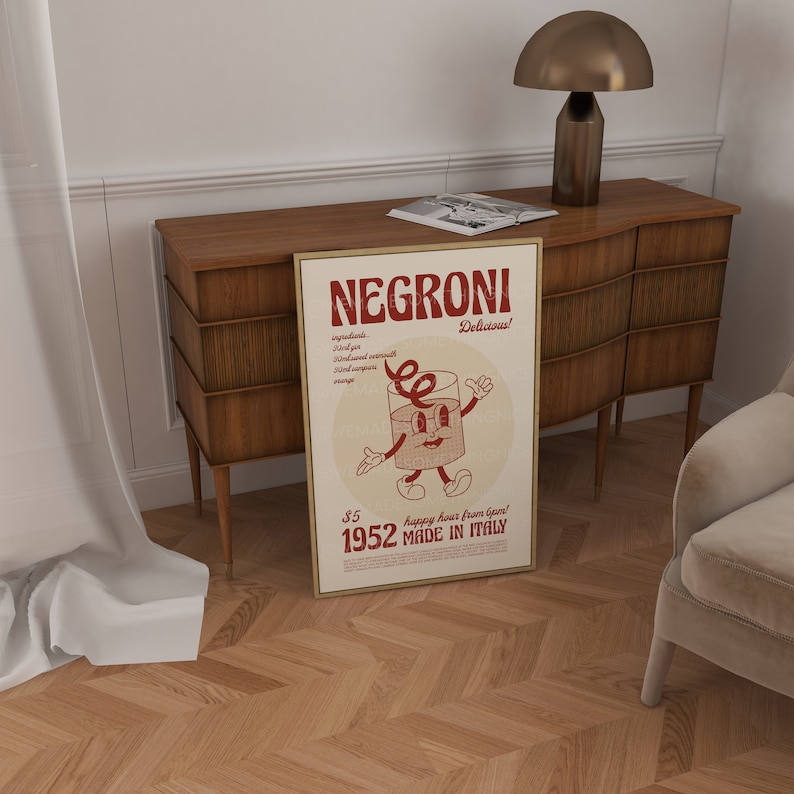 Peut inclure: Une affiche encadr&eacute;e rectangulaire pr&eacute;sentant un graphique rouge et cr&egrave;me d'un verre &agrave; cocktail anim&eacute; avec des bras et des jambes. Le texte indique NEGRONI, Delicious, ingredients, 1952, MADE IN ITALY, et happy hour from 6pm, avec un prix de 5 $.