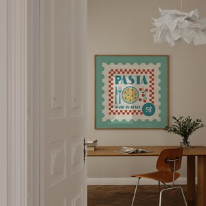 May include: A framed poster with a vintage design. The poster features the word "PASTA" in teal, a teal border, and a red and white checkered pattern. The words "MADE IN ITALY" and the number "5$" are also visible on the poster.