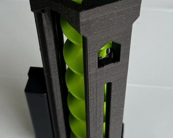 May include: A black 3D printed hexagonal tower with a green spiral inside. The tower has a small window on the side.