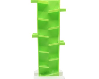 Könnte beinhalten: Ein grüner Spielzeugturm aus Plastik mit einer weißen sechseckigen Basis. Der Turm hat eine Reihe von Stufen, die eine Wendeltreppe bilden.