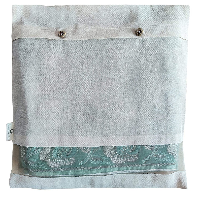 May include: A white cotton drawstring bag with a clear plastic window, showing a teal blue fabric with a floral pattern. The bag has two brown buttons and the text "forever after" on the front.
