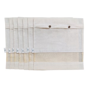 May include: Set of eight white cotton produce bags with a mesh bottom and a button closure. The bags are stacked on top of each other.