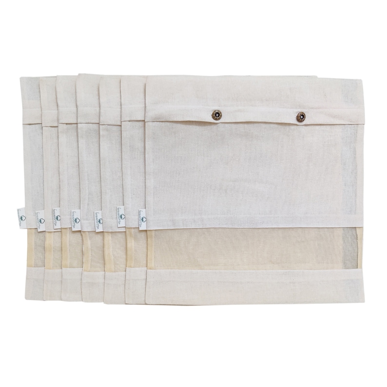 May include: Set of eight white cotton produce bags with a mesh bottom and a button closure. The bags are stacked on top of each other.