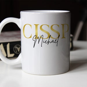 May include: White ceramic coffee mug with a gold inscription that reads "CISSP Michael".