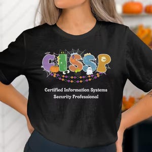 May include: Black t-shirt with the word "CISSP" in colorful, Halloween-themed letters. The design includes a pumpkin, a ghost, and a spiderweb. Below the graphic, the text reads "Certified Information Systems Security Professional."