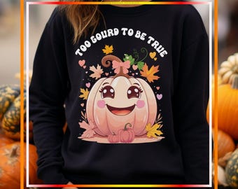 May include: Black sweatshirt with a cute cartoon pumpkin graphic. The pumpkin has a smiling face, a pink bow, and is surrounded by leaves and hearts. The text "TOO GOURD TO BE TRUE" is above the pumpkin.