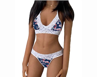 May include: A white lace lingerie set with a navy blue and red print featuring the Atlanta Braves logo and text. The set includes a halter top and a thong.