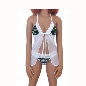 May include: White lace lingerie with a blue and green Seattle Seahawks themed print. The lingerie includes a halter top and matching underwear.