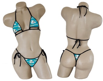 May include: A black bikini with a teal and gold Miami Dolphins print. The bikini top has a halter style and the bottom is a string bikini.