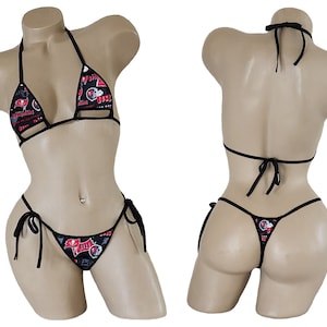May include: Black bikini with a red and white print featuring a football helmet and other sports-related graphics. The bikini top has a halter style and the bottom is a string bikini.