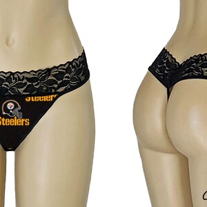 May include: Black lace g-string panty with a Pittsburgh Steelers logo and the words "Steelers" printed on the front.