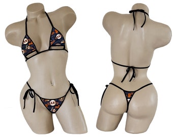 May include: Black bikini with a San Francisco Giants themed print. The top is a triangle style with adjustable straps and a small cut-out in the center. The bottom is a cheeky style with adjustable ties on the sides.