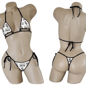 May include: A white and black bikini with a repeating pattern of the words "Chicago Sox". The bikini top is a triangle style with adjustable straps. The bikini bottom is a cheeky style with adjustable ties on the sides.