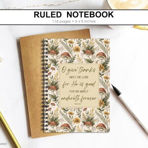 May include: Ruled notebook with a floral and mushroom design. The notebook has 118 pages and measures 15 x 20 cm. The cover features the text "O give thanks unto the Lord for He is good for His mercy endureth forever."