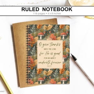 May include: Ruled notebook with a fall-themed cover featuring leaves and mushrooms. The notebook is 15 x 20 cm and has 118 pages. The cover includes the text "O give thanks unto the Lord for He is good for His mercy endureth forever."