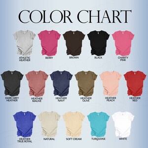 May include: Color chart showing 18 different t-shirt colors. The colors include athletic heather, berry, brown, black, charity pink, dark grey heather, heather mauve, heather navy, heather olive, heather peach, heather red, heather true royal, natural, soft cream, turquoise, and white.