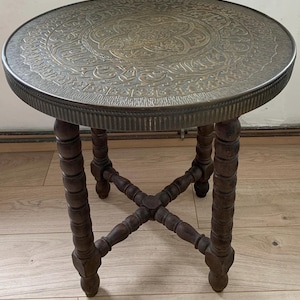 Antique copper side table with can legs, round table with an oriental repoussé copper top, antique oriental style side table