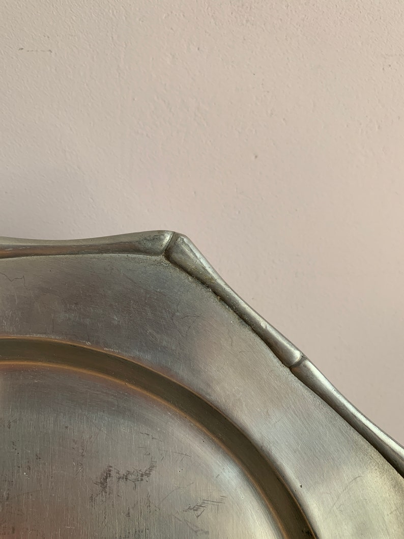 A Set of 8 Octagonal Dishes, Elegant Trivet in Stylish White Iron, the