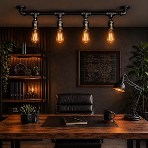 May include: A black industrial ceiling light with four Edison-style bulbs illuminates a wooden desk. The bulbs give off a warm, orange light. The desk is in a home office with a black leather chair and a framed blueprint on the wall.