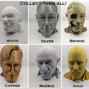 May include: A collection of six busts in various colors: white, silver, bronze, copper, marble, and gold. Each bust is a detailed representation of a person's head and shoulders. The text "COLLECT THEM ALL!" is at the top, with the color names below each bust.