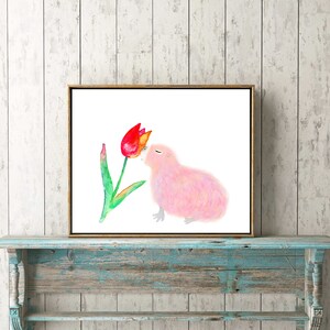 May include: A watercolor painting of a pink bird with its beak touching a red tulip. The bird is fluffy and has a closed eye. The tulip is green with a red and yellow flower.