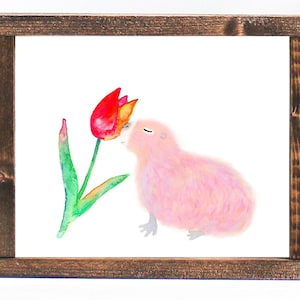 May include: A watercolor painting of a pink guinea pig smelling a red and yellow tulip.