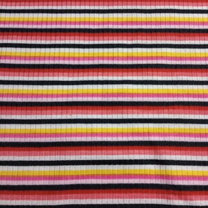 May include: Striped fabric with alternating bands of red, pink, yellow, white and black.