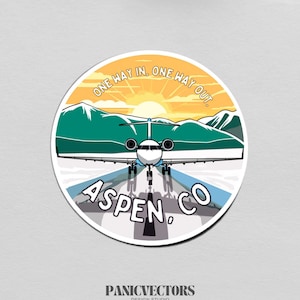 May include: A round sticker with a blue and white airplane flying over a green mountain range with a yellow sun rising behind it. The text "One Way In. One Way Out. Aspen, CO" is printed on the sticker.