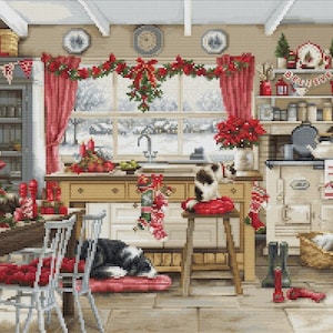 Puede incluir: Una acogedora cocina decorada para Navidad con una guirnalda roja y blanca, una ventana con vista a la nieve, un perro blanco y negro durmiendo en un cojín rojo y una estufa blanca con un letrero rojo y blanco que dice "Cree".