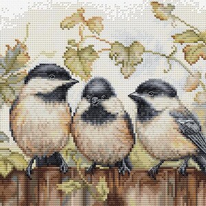 May include: Cross-stitch image of three small birds with black caps, tan bodies, and grey wings perched on a wooden fence. The background features green and yellow leaves, creating a nature scene.