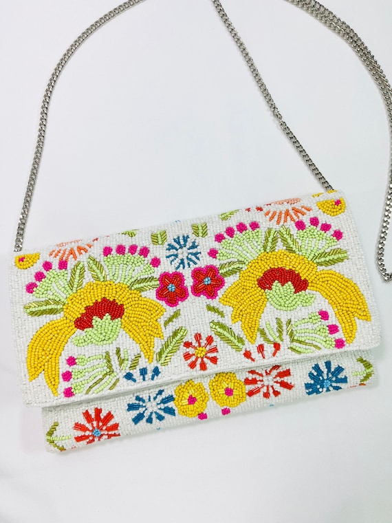 A fully beaded floral clutch that looks like it took hours to make — the kind of handmade accessory that gets compliments at every event.