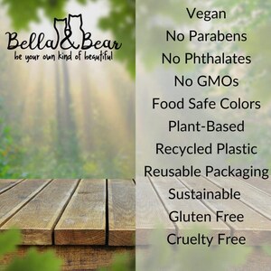 May include: A wooden table with a blurred background of green trees. Text on the right side of the image reads: Vegan, No Parabens, No Phthalates, No GMOs, Food Safe Colors, Plant-Based, Recycled Plastic, Reusable Packaging, Sustainable, Gluten Free, Cruelty Free.