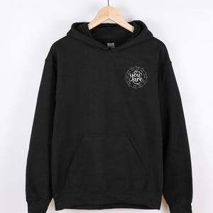 May include: Black hooded sweatshirt with a white graphic print that says "Be you are" in a circle.