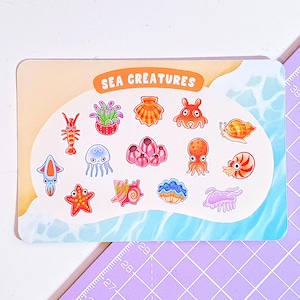 May include: A sticker sheet featuring colourful illustrations of sea creatures, including a starfish, jellyfish, seashells, and an octopus. The sheet is titled "SEA CREATURES".