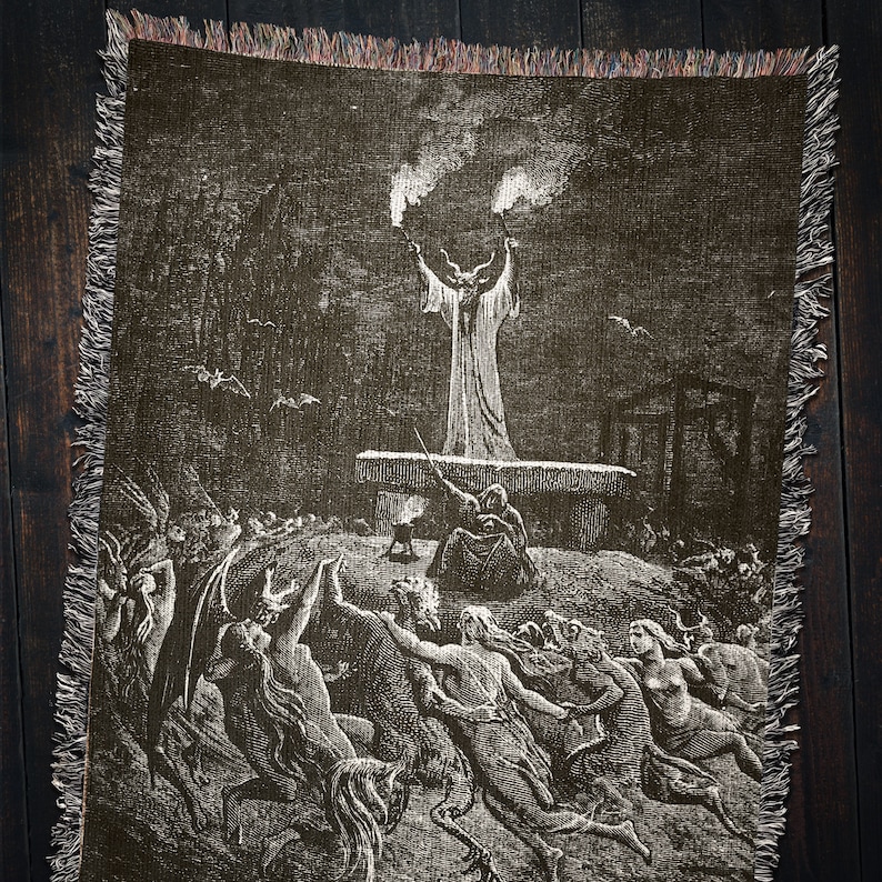 May include: A black and white tapestry depicting a scene from a classic horror story. A horned figure stands on a platform, raising their arms in the air. Below, a group of figures with horns and tails are gathered around the platform.