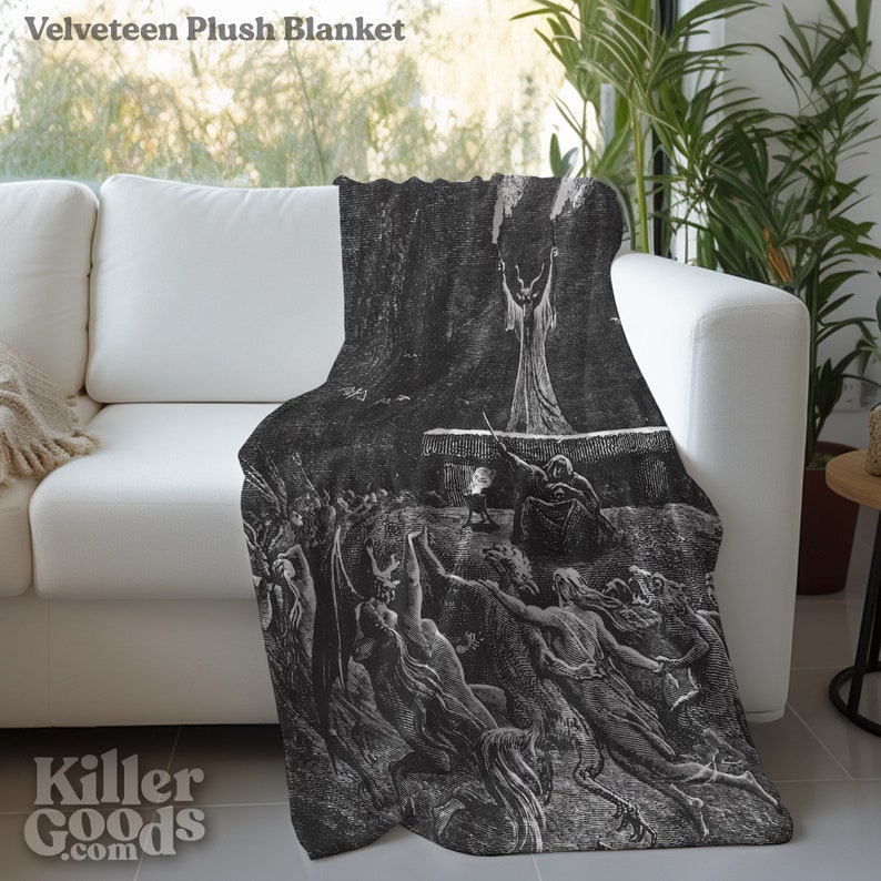 May include: A black and white plush blanket featuring a vintage illustration of a scene from Dante's Inferno. The illustration depicts a group of figures in a dark, shadowy setting.