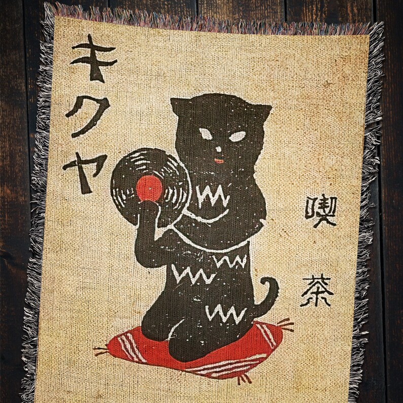 May include: A black cat with a record player and the Japanese text "キクヤ" and "喫茶" on a tan background.