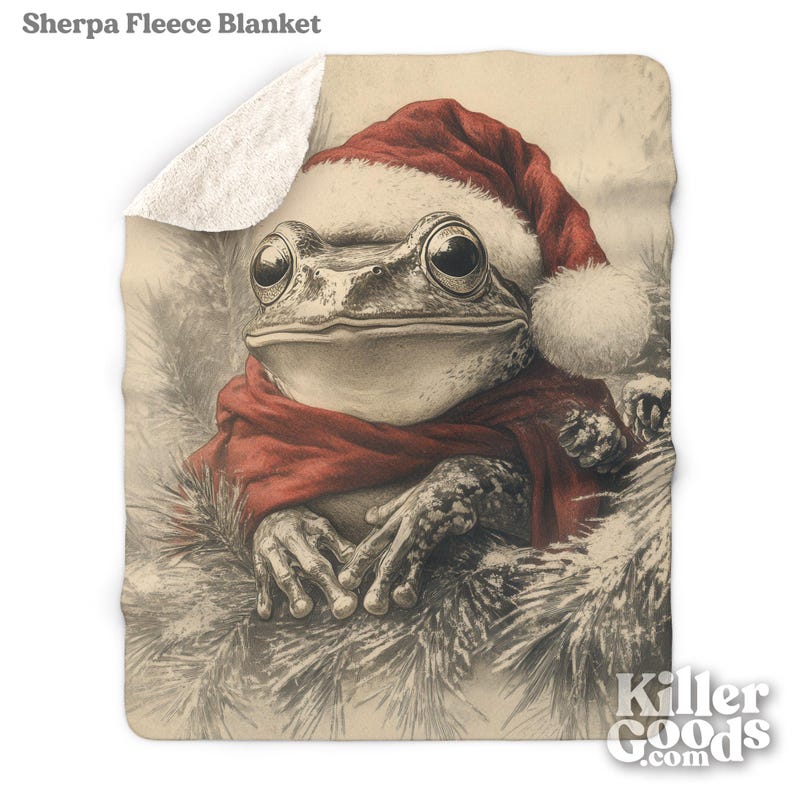 May include: A brown and green frog wearing a red Santa hat and scarf, sitting in a snowy forest setting. The frog is looking at the viewer.