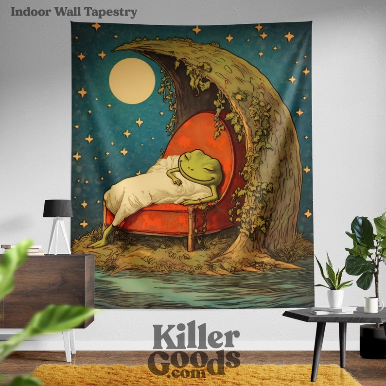 May include: A tapestry depicting a green frog asleep in a red armchair beneath a crescent moon. The moon is surrounded by stars and the frog is resting on a bed of green leaves. The tapestry has a vintage, whimsical style.