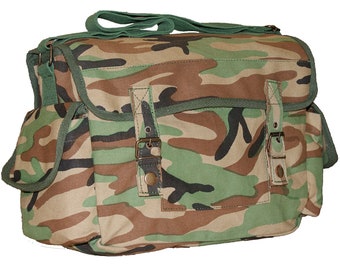 May include: A camouflage-patterned messenger bag with a green shoulder strap and trim. The bag features two side pockets, a front flap with two buckle closures, and a top handle. The bag's colors include shades of green, brown, and tan.