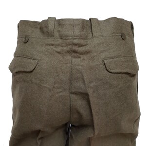May include: A pair of dark green wool pants with two back pockets and a button closure at the waist.