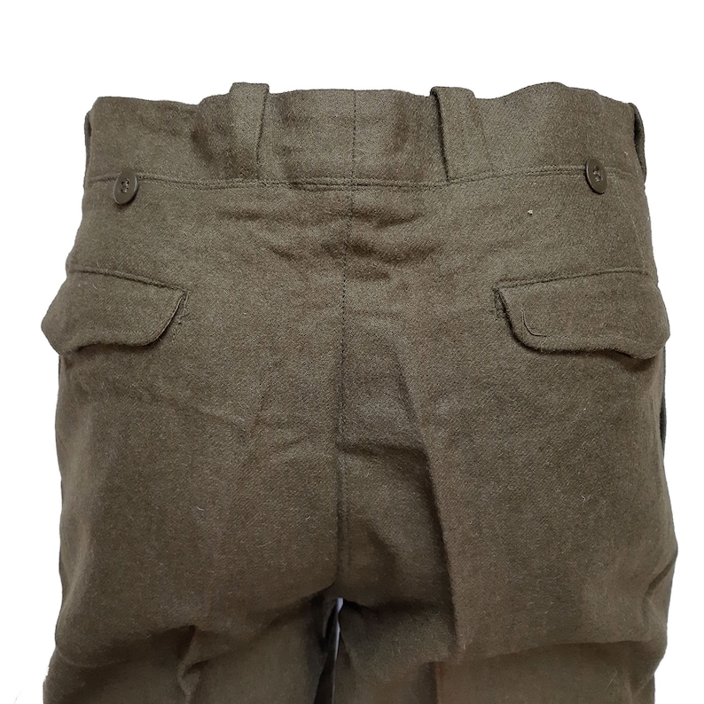 May include: A pair of dark green wool pants with two back pockets and a button closure at the waist.