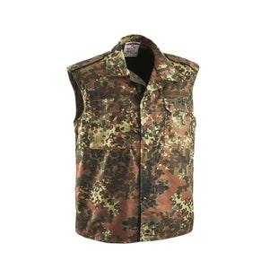 May include: A sleeveless camouflage vest in a brown, green, and tan pattern. The vest has two chest pockets with button closures, a collared neckline, and a button-up front. The vest appears to be made of a durable fabric.
