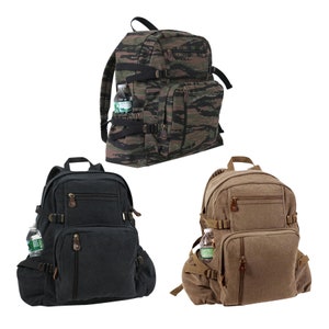 May include: Three canvas backpacks in different colours and patterns. The first backpack is camouflage, the second is black, and the third is brown. Each backpack has a zipped front pocket, two side pockets, and adjustable straps.