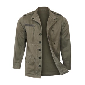 May include: A green utility jacket with a button front closure, two zippered pockets, and a flap pocket on the left side.