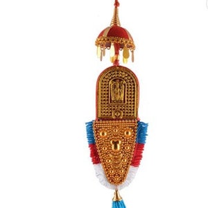 May include: A gold and red decorative hanging ornament with a tassel. The ornament features a red and gold dome with a gold tassel and a gold and red patterned design.