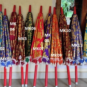 May include: Twelve colorful umbrellas with gold and silver accents and white lace trim. The umbrellas are labeled MK01 through MK12.